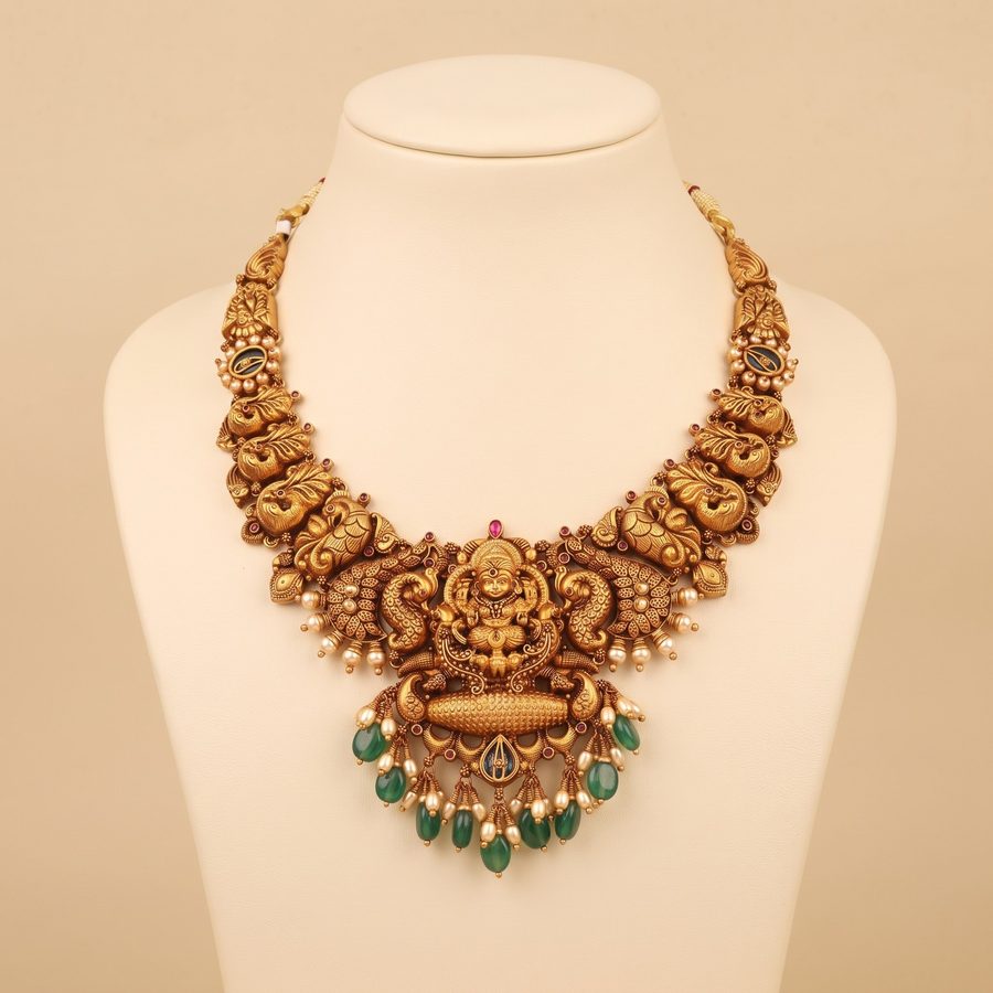 Bridal gold necklace set with matching maang tikka and jhumka earrings
